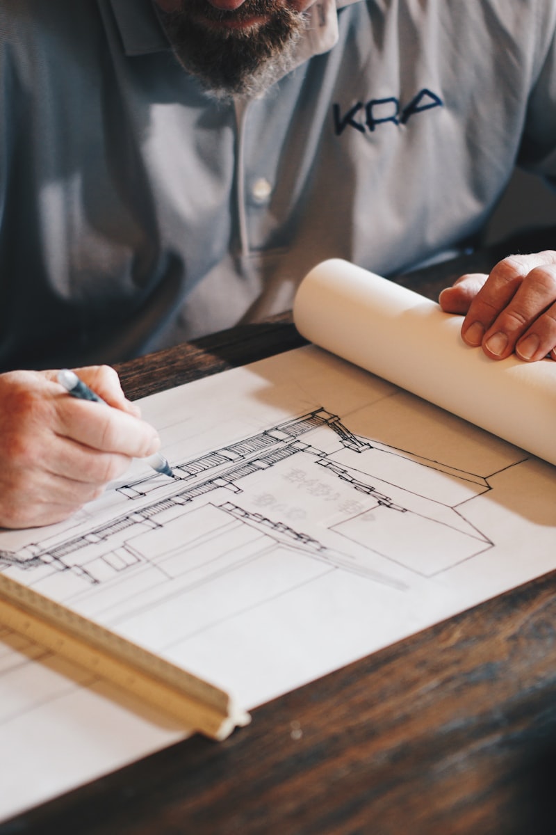 Inspector working over blueprints, photos documented on-device with SnapProof